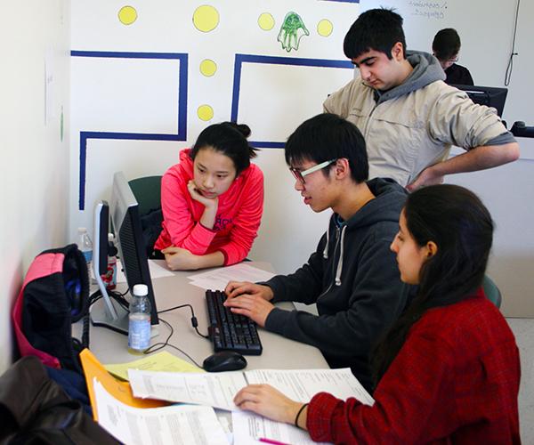 A team of students working on a computer programming problem